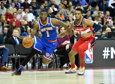 Jan 17, 2019; London, United Kingdom; New York Knicks guard Emmanuel Mudiay (1) drives to the basket past Washington Wizards forward Troy Brown Jr. (6) during the third quarter at The O2 Arena. Mandatory Credit: Steve Flynn-USA TODAY Sports