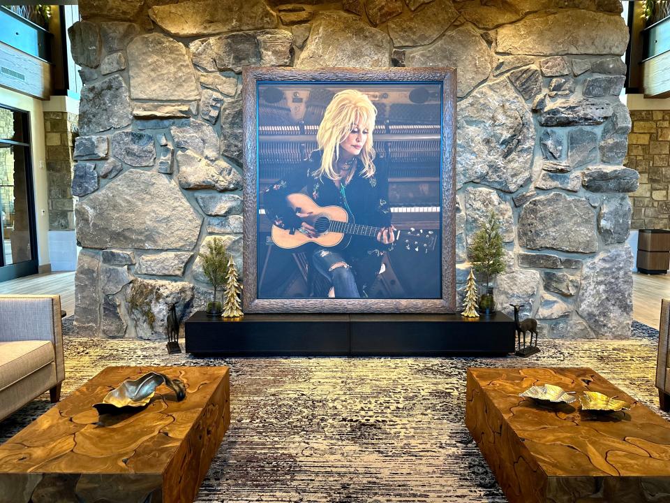 Framed photo of Dolly Parton in front of a stone wall in the HeartSong lobby