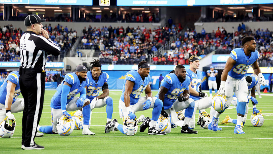 Los Angeles Chargers players, pictured here appearing visibly distressed. 