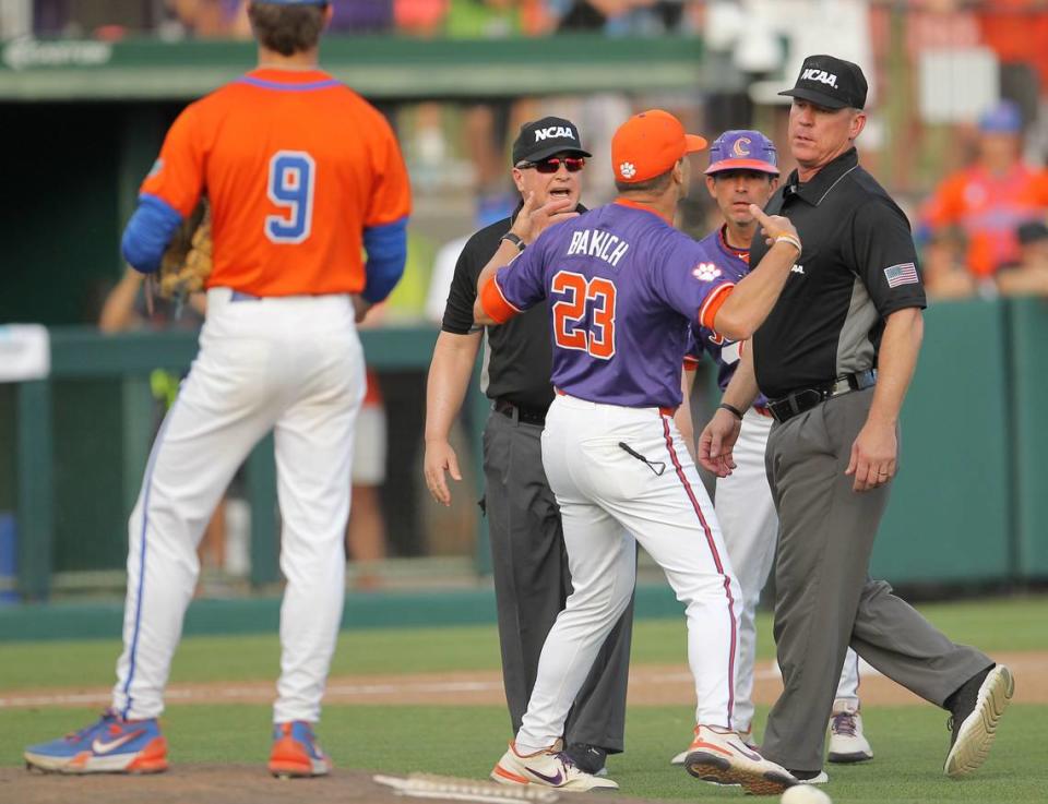 Clemson head coach Erik Bakich is backup by umpires while he tries to get to Greg Harmon, who ejected him during NCAA Super Regionals action on Sunday, June 9, 2024 in Clemson, S.C.