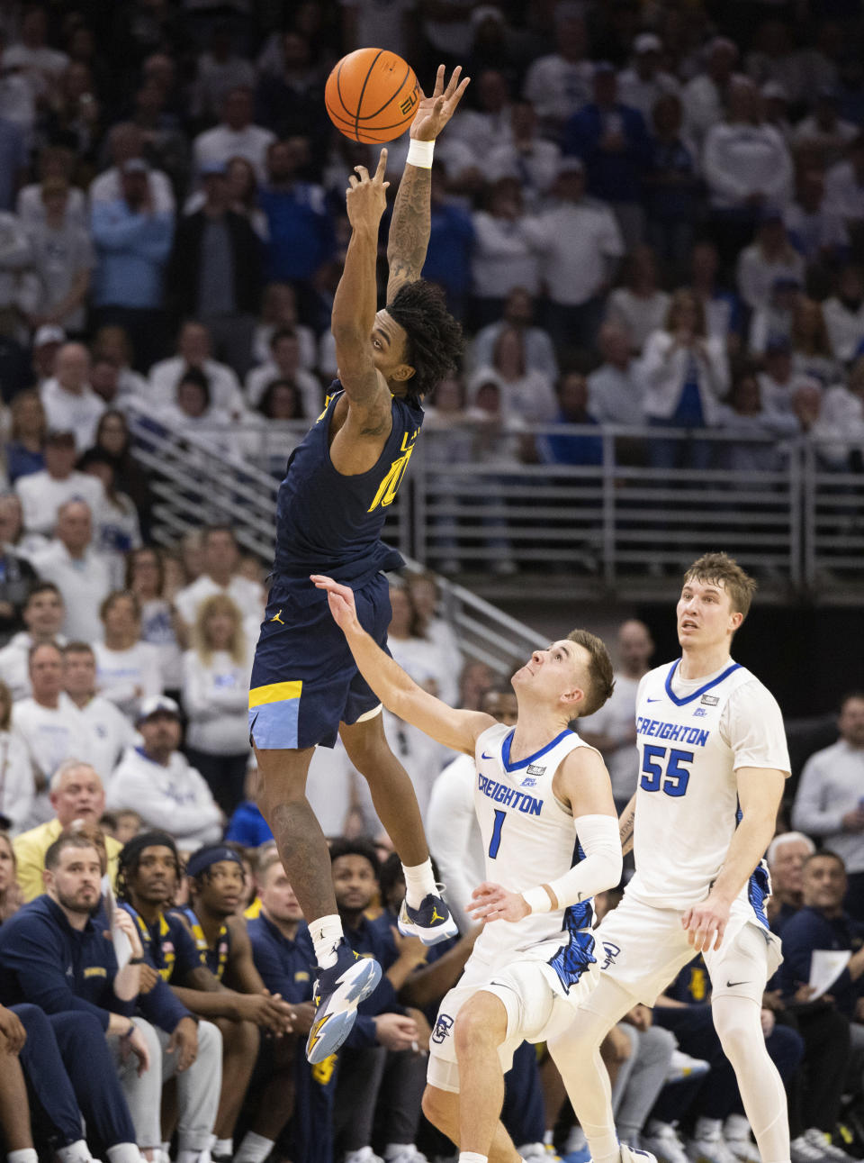Marquette's Zaide Lowery (10) leaps to reach an overthrown pass against Creighton's Steven Ashworth (1) and Baylor Scheierman (55) during the second half of an NCAA college basketball game Saturday, March 2, 2024, in Omaha, Neb. Creighton defeated Marquette 89-75. (AP Photo/Rebecca S. Gratz)
