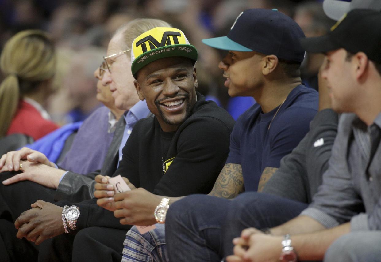 Floyd Mayweather Jr. sits courtside during the first half of Game 6 in a second-round NBA basketball playoff series between the Los Angeles Clippers and the Houston Rockets in Los Angeles, Thursday, May 14, 2015. (AP Photo/Jae C. Hong)