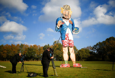 Members of the media film the 11-metre effigy of Boris Johnson unveiled today ahead of the Edenbridge Bonfire Celebrations in Edenbridge, Britain October 31, 2018. REUTERS/Henry Nicholls