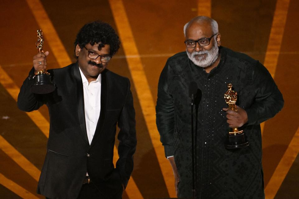Indian composer M.M. Keeravaani (R) and Indian musician Chandrabose accept the Oscar for Best Music (Original Song) for "Naatu Naatu" from "RRR" onstage during the 95th Annual Academy Awards at the Dolby Theatre in Hollywood, California