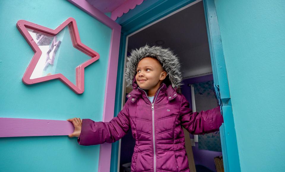 Zoe Smith beams from the doorway of her custom-built underwater-themed playhouse, which was delivered to the 4-year-old's home in Somerset, Massachusetts, after being revealed on Thursday.