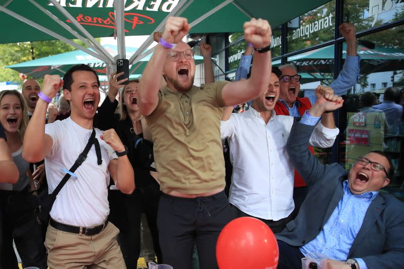 Reactions to the first exit polls from Social Democratic Party candidate Olaf Scholz and supporters at the party headquarters