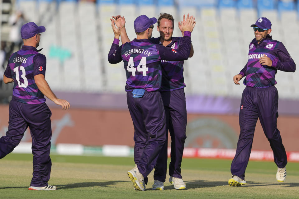 Scotland's Josh Davey, second right, celebrates with teammate Richie Berrington after taking the wicket Papua New Guinea's Simon Atai during the Cricket Twenty20 World Cup first round match between Scotland and Papua New Guinea in Muscat, Oman, Tuesday, Oct. 19, 2021. (AP Photo/Kamran Jebreili)