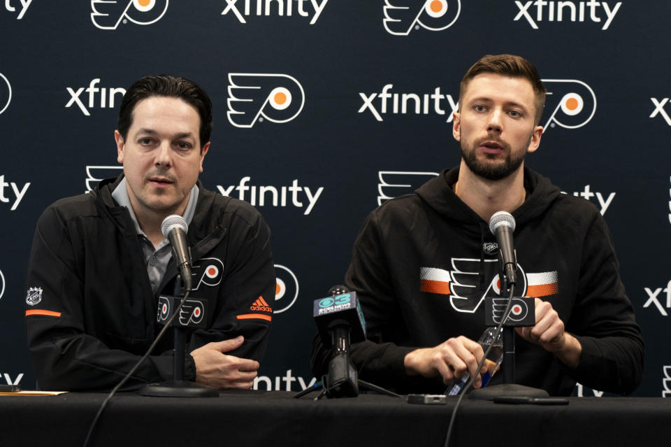 Philadelphia Flyers Ivan Fedotov, right, takes questions from the media as general manager Daniel Briere looks on during an NHL hockey press conference, Friday, March 29, 2024, in Voorhees, N.J. (AP Photo/Chris Szagola)