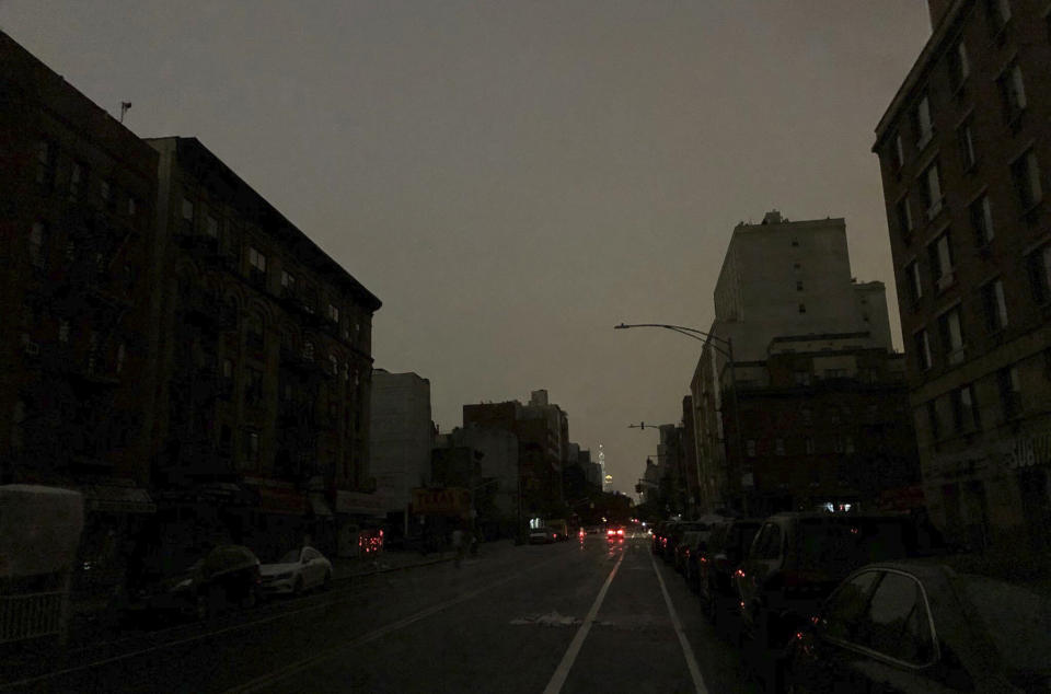 Buildings in Harlem sit dark during a power outage early, Friday, Aug. 7, 2020, in New York. A power outage cast darkness across dozens of blocks in New York City early Friday, as many people in the city were still without electricity in the aftermath of Tropical Storm Isaias. A statement from Con Edison says a transmission system problem caused three networks in Manhattan to lose their electric supply just after 5 a.m. (Tokuyuki Komiyama via AP)