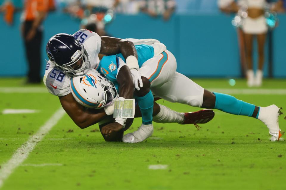 September 30, 2024; Miami Gardens, Florida, USA; Tennessee Titans linebacker Harold Landry III (58) sacks Miami Dolphins quarterback Tyler Huntley (18) in the first quarter at Hard Rock Stadium. Mandatory attribution: Sam Navarro-Imagn Images