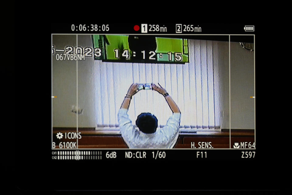 Russian opposition leader Alexei Navalny is partially seen on a camera screen filming a TV screen, as he appears in a video link provided by the Russian Federal Penitentiary Service in a courtroom at Moscow City Court in Moscow, Russia, on Wednesday, May 31, 2023. Imprisoned Russian opposition leader Alexei Navalny said in April that he was facing new extremism and terrorism charges that could keep him behind bars for life. (AP Photo/Alexander Zemlianichenko.)