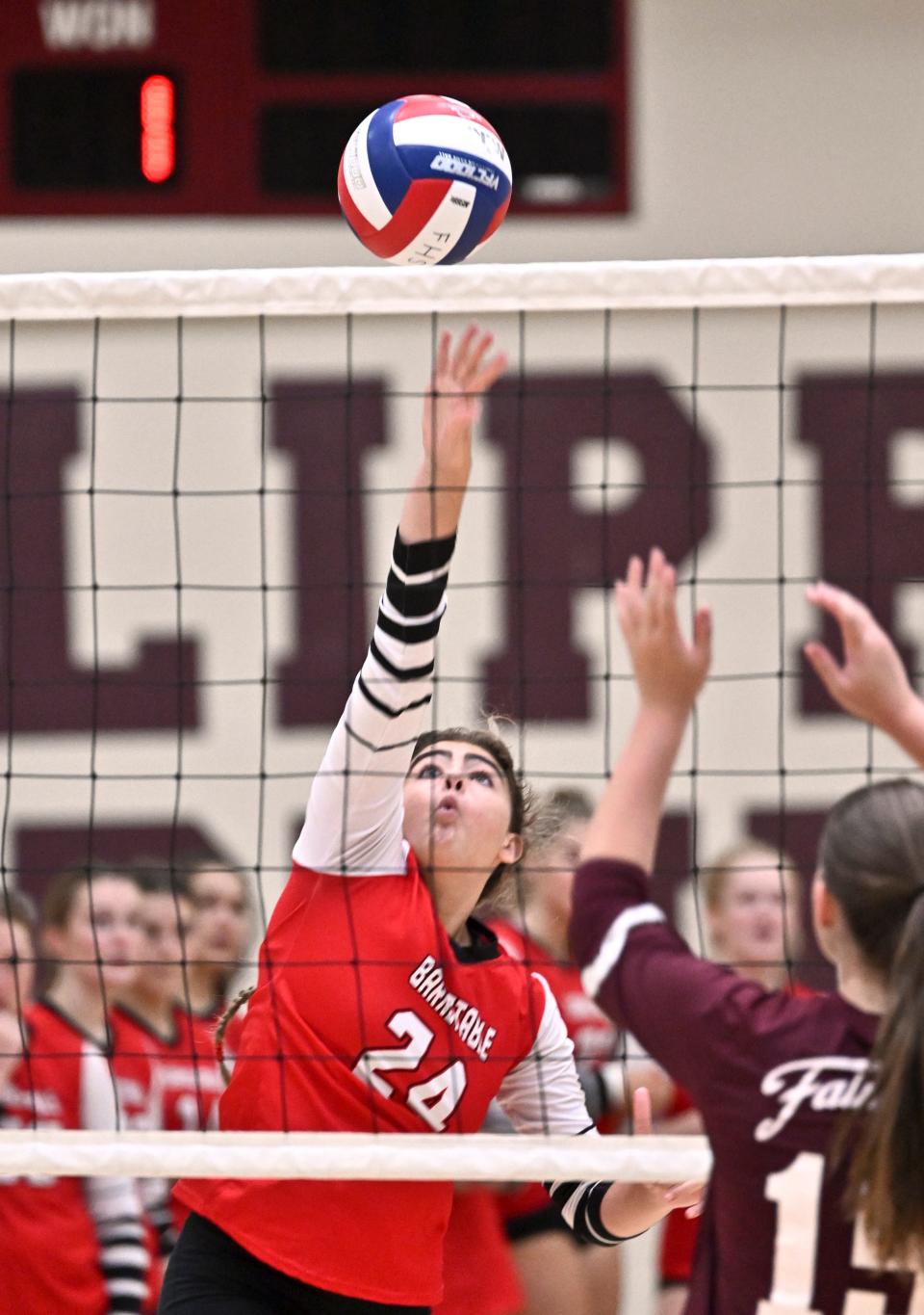 FALMOUTH   9/19/22    Charlotte Sullivan of Barnstable pushes the ball over the net against Aurora Kinworthy of  Falmouth.