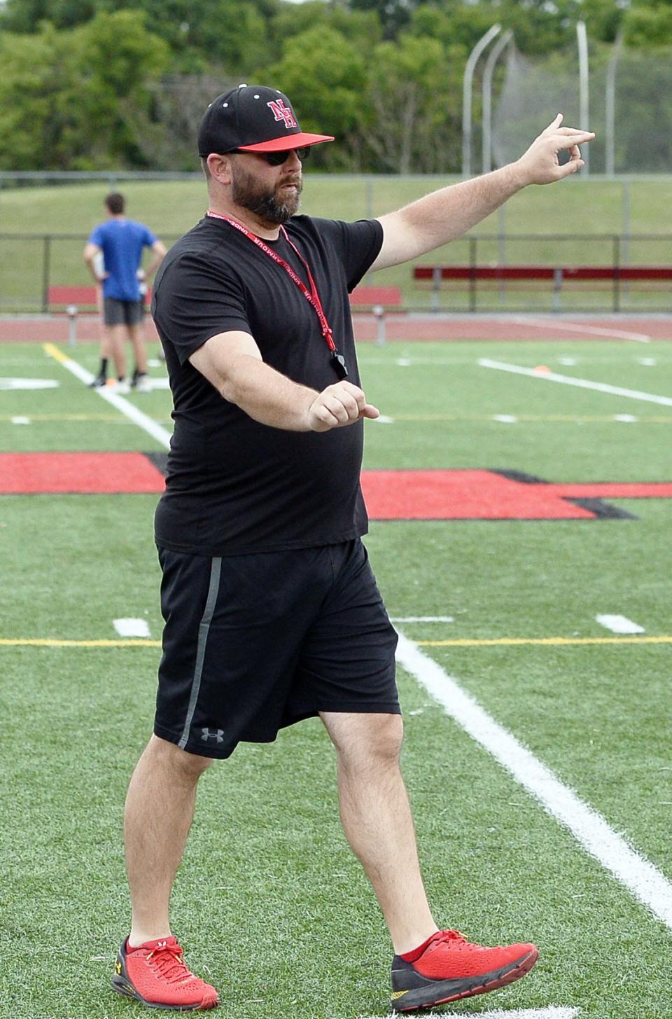 North Hagerstown football coach Nathan Butts gives instructions during a voluntary team workout Tuesday at Mike Callas Stadium.