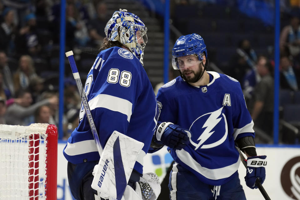 Tampa Bay Lightning goaltender Andrei Vasilevskiy (88) celebrates with right wing Nikita Kucherov (86) after the team defeated the Pittsburgh Penguins during an NHL hockey game Wednesday, Dec. 6, 2023, in Tampa, Fla. (AP Photo/Chris O'Meara)