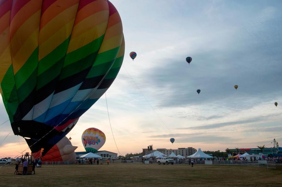 Hot air balloons fly over OWA during the Gulf Coast Hot Air Balloon Festival at OWA in Foley, Alabama on Thursday, May 4, 2023.