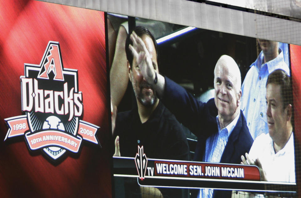 FILE - In this Aug. 24, 2008, file photo, Republican presidential candidate, Sen. John McCain, R-Ariz., is seen on the giant replay screen during a baseball game between the Arizona Diamondbacks and Florida Marlins at Chase Field in Phoenix. The sight of McCain sitting in the stands at Chase Field became so commonplace few people seemed to even notice. The senator from Arizona would get handshakes and take pictures with fans, but he was there just to be one of them, cheering on the home team. McCain died Saturday, Aug. 25, 2018, after battling brain cancer and the Arizona sports community mourned him across the Valley of the Sun. He was 81. (AP Photo/Mary Altaffer, File)