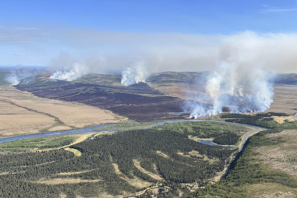 In this aerial photo provided by the BLM Alaska Fire Service, the East Fork Fire burns about 25 miles north of St. Mary's, Alaska on June 2, 2022. The largest documented wildfire ever burning through tundra in southwest Alaska is within miles of two Alaska Native villages, prompting dozens of residents with respiratory problems to voluntarily evacuate. (Pat Johnson, BLM Alaska Fire Service via AP)