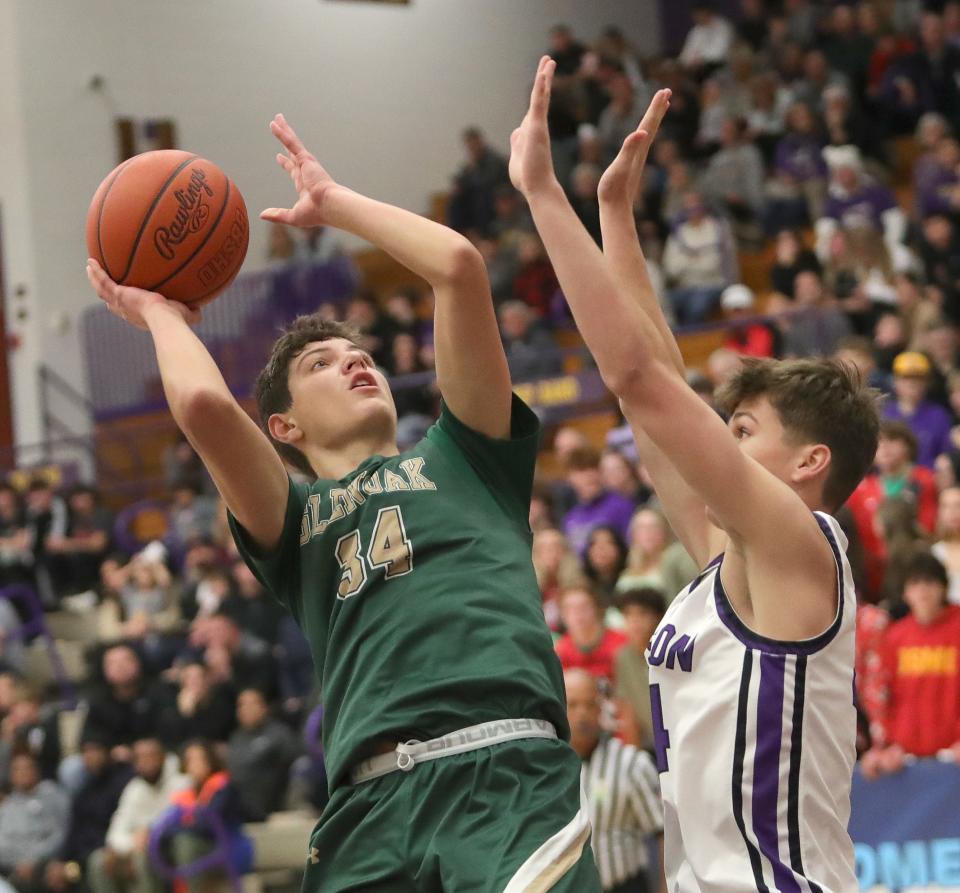 GlenOak's Reese Zerger puts up a shot defended by Jackson's Kyle Monterrubio, Friday, Dec. 22, 2023.