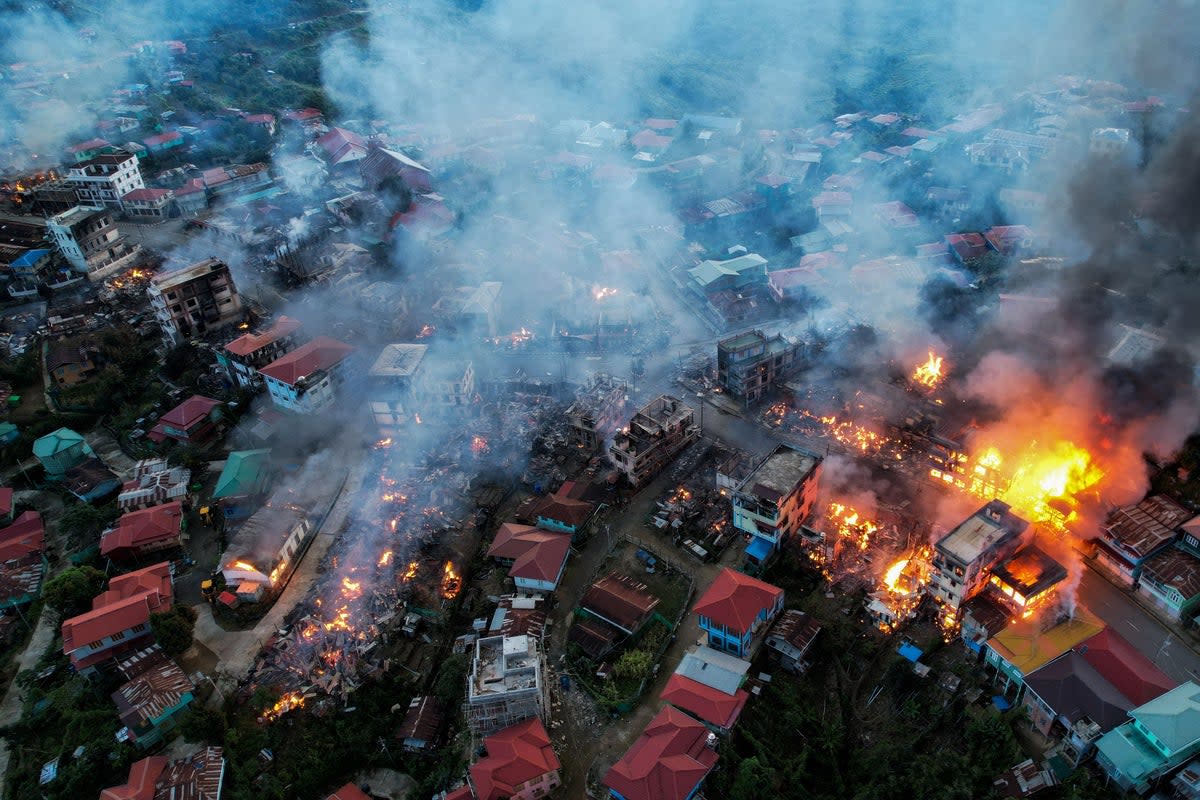 FILE: This aerial photo taken on 29 October 2021 show smokes and fires from Thantlang, in Chin State, where more than 160 buildings have been destroyed caused by shelling from Junta military troops, according to local media (AFP via Getty Images)