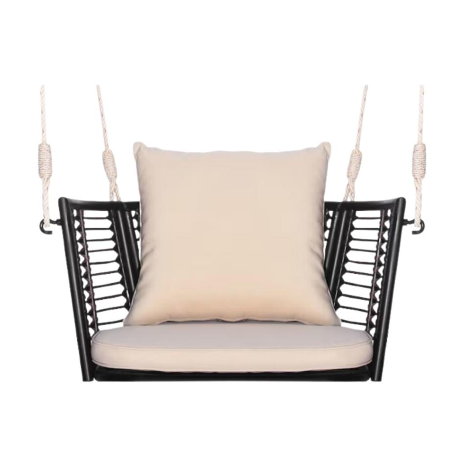 Backyard swing with a white cushion