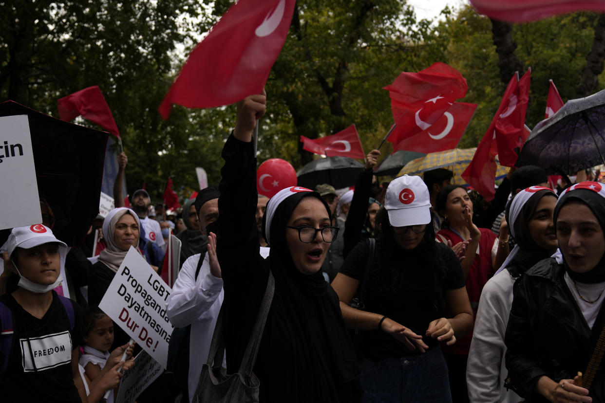 Turkish demonstrators chant slogans while holding Turkish flags during a anti LGBTI+ protest in Fatih district of Istanbul, Sunday, Sept. 18, 2022. (AP Photo/Khalil Hamra)