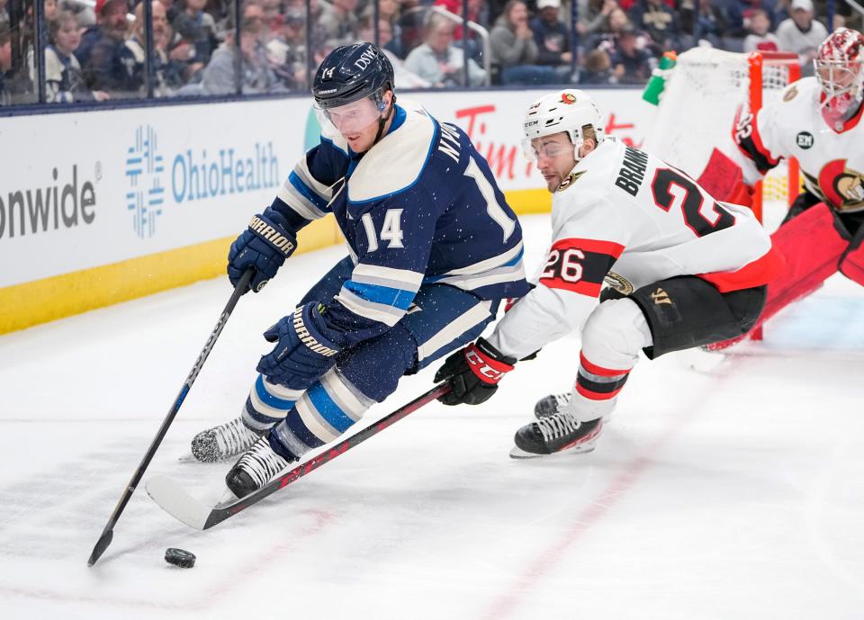 Columbus Blue Jackets center Gustav Nyquist (14) moves the puck around Ottawa Senators defenseman Erik Brannstrom (26) during the first period of the NHL game at Nationwide Arena on April 22, 2022.