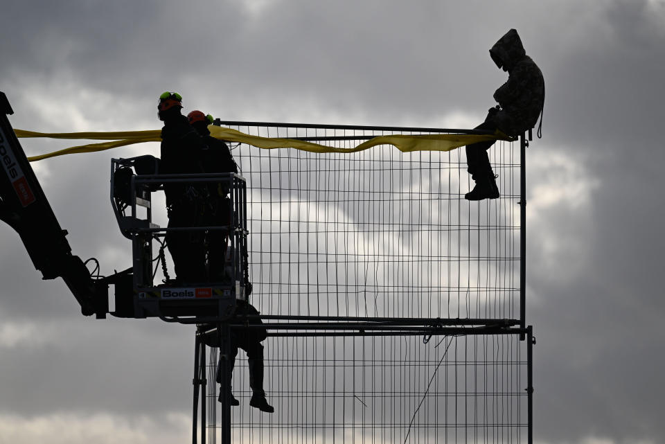 A demonstrator is lifted from a wire scaffold by police with the help of a lifting platform during the clearing of the village of Luetzerath, Germany, on January 11, 2023. / Credit: Federico Gambarini/picture alliance/Getty