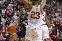 Penn State guard Sam Sessoms (3) passes the ball off to a teammate as his drive to the basket was stopped by Indiana forward Trayce Jackson-Davis (23) during the first half of an NCAA college basketball game, Wednesday, Jan. 26, 2022, in Bloomington, Ind. (AP Photo/Doug McSchooler)