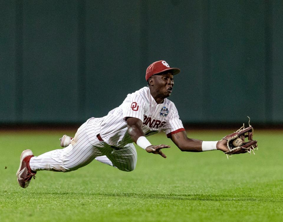 OU left fielder Kendall Pettis makes a diving catch against Mississippi in the ninth inning during Game 1 of College World Series finals on June 25 in Omaha, Neb.