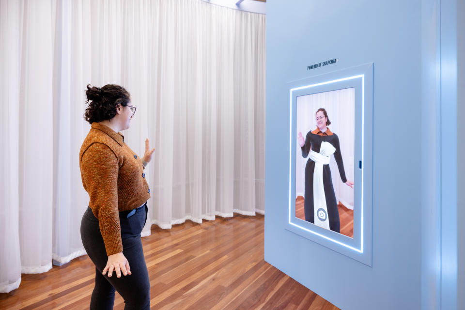 Three Snap AR Mirrors allow museum visitors to try on ensembles, including a Dior one seen here.