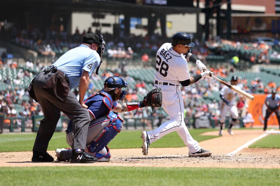 Javier Baez of the Detroit Tigers hits an RBI ground ball to shortstop in the third inning in front of Jonah Heim #28 of the Texas Rangers at Comerica Park on May 31, 2023 in Detroit, Michigan.