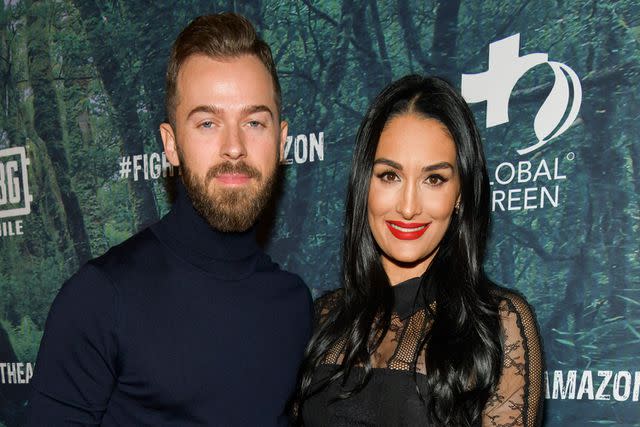 <p>Rodin Eckenroth/Getty</p> Artem Chigvintsev (L) and Nikki Bella attend the PUBG Mobile's #FIGHT4THEAMAZON Event at Avalon Hollywood on December 9, 2019 in Los Angeles, California.