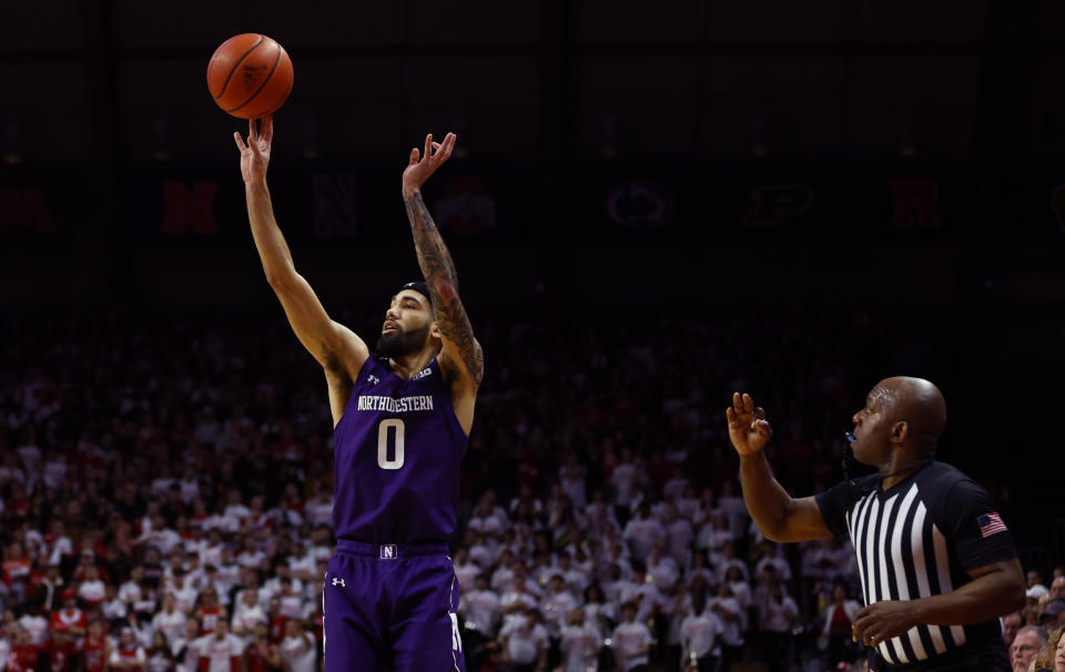 Northwestern guard Boo Buie (0) takes a 3-point shot against Rutgers during the first half of an NCAA college basketball game, Sunday, March 5, 2023, in Piscataway, N.J. (AP Photo/Noah K. Murray)