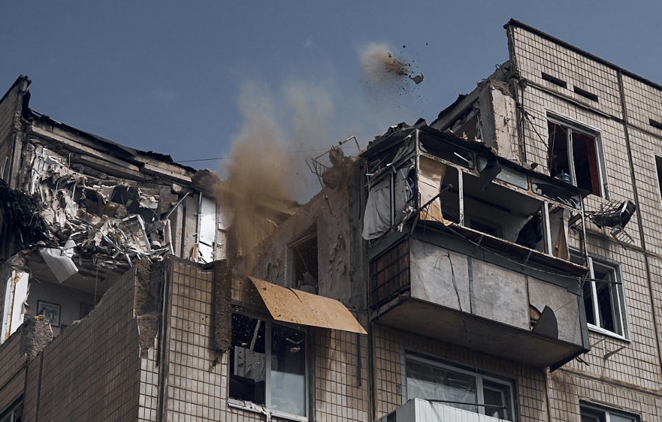 A man cleans an apartment destroyed after Russian shelling in Nikopol, Ukraine, Monday, Aug. 15, 2022. (AP Photo/Kostiantyn Liberov)