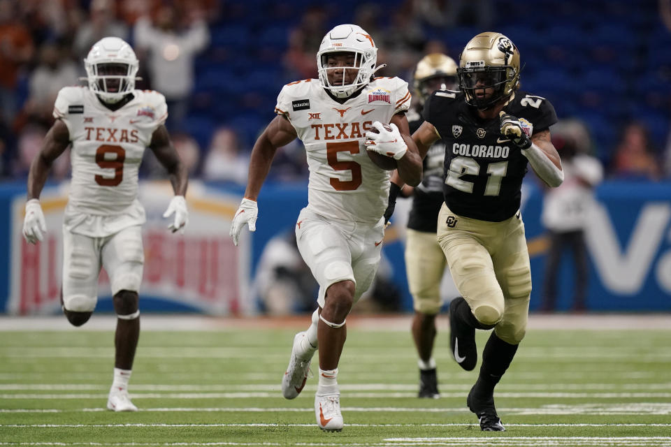 Texas running back Bijan Robinson (5) carries during the first half against Colorado in the Alamo Bowl NCAA college football game Tuesday, Dec. 29, 2020, in San Antonio. (AP Photo/Eric Gay)