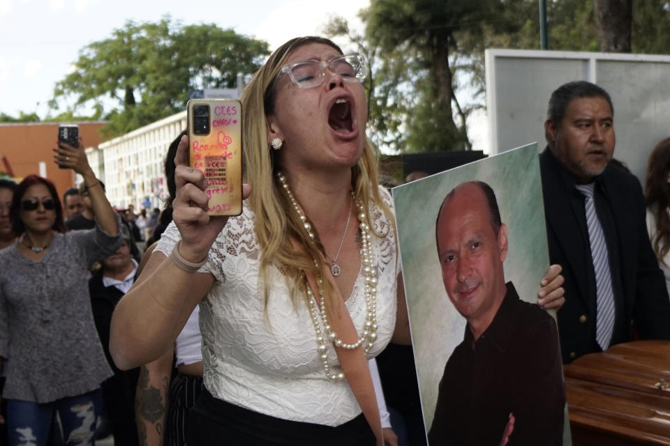 A niece of slain activist Adolfo Enriquez Vanderkam shouts asking for justice, at his funeral in Leon, Guanajuato state, Mexico, Thursday, Nov. 23, 2023. Enriquez Vanderkam was shot Wednesday night as he was leaving a taco shop. (AP Photo/Mario Armas)