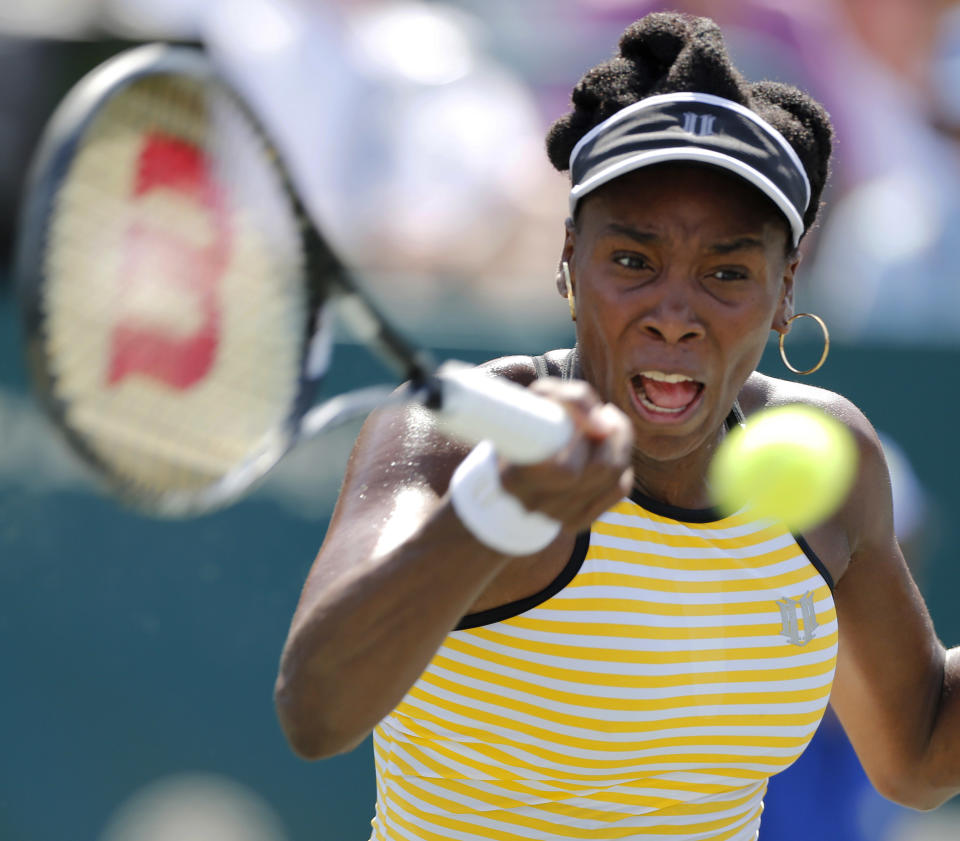 Venus Williams returns to Eugenie Bouchard, of Canada, during the Family Circle Cup tennis tournament in Charleston, S.C., Thursday, April 3, 2014. (AP Photo/Mic Smith)