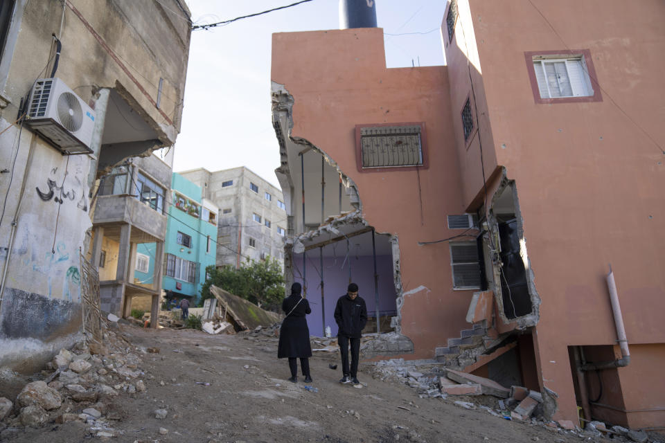 Palestinians inspect the damaged houses following an Israeli army raid in the West Bank refugee camp of Nour Shams, Tulkarem, Thursday, Feb. 8, 2024. The Al Aqsa Martyrs' Brigades, a Palestinian militant group, said three of its members were killed in the Israeli raid. Israel said its troops shot the militants after an exchange of fire. (AP Photo/Nasser Nasser)