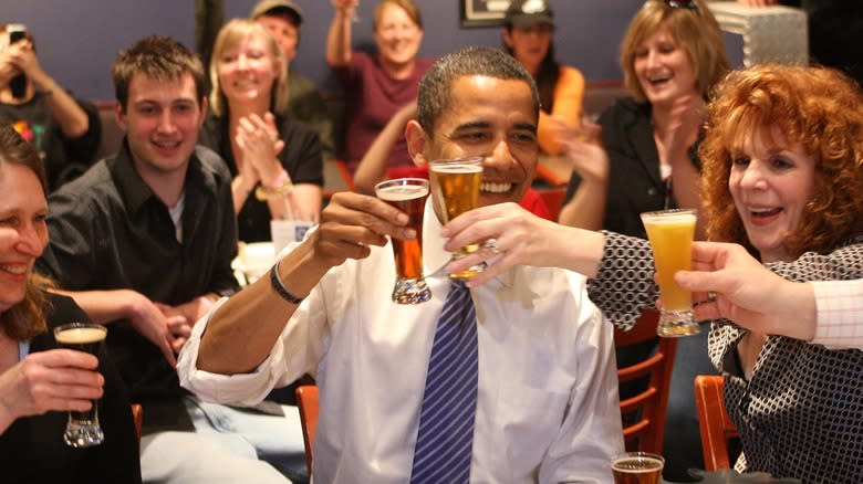 Barak Obama toasting with beer