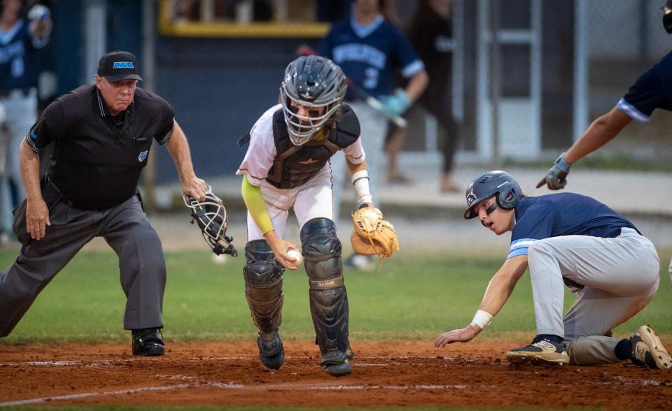 Newsome (7) Ryan Spitzer slides safely under the tag of Winter Haven catcher (99) Matthew Phieffer during a 7A District 6 baseball tournament at Winter Hven High School in Winter Haven Fl. Tuesday April 30, 2024.
Ernst Peters/The Ledger