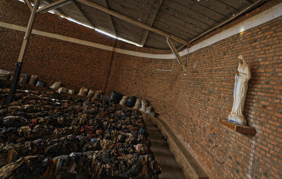 Piles of clothes belonging to some of those who were slaughtered as they sought refuge inside the church cover the pews as a memorial to the thousands who were killed during the 1994 genocide in and around the Catholic church in Nyamata, Rwanda Thursday, April 4, 2019. Rwanda will commemorate on Sunday, April 7, 2019 the 25th anniversary of when the country descended into an orgy of violence in which some 800,000 Tutsis and moderate Hutus were massacred by the majority Hutu population over a 100-day period in what was the worst genocide in recent history. (AP Photo/Ben Curtis)