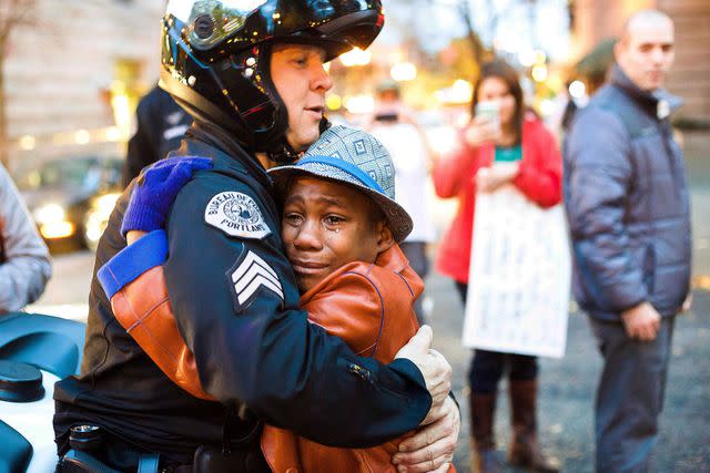 Johnny Huu Nguyen/AP Devonte Hart hugging a police officer in 2014.