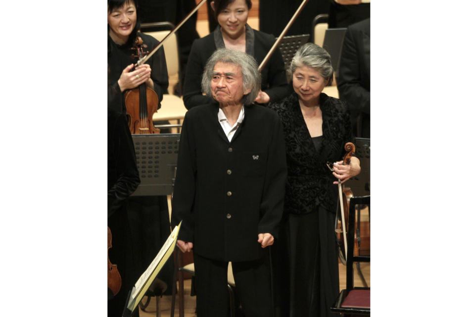 FILE - Seiji Ozawa, center, reacts as he greets the audience after a performance with violoncellist Dai Miyata, unseen, and the Mito Chamber Orchestra at Suntory Hall in Tokyo, Sunday, Jan. 22, 2012. World-renowned conductor Ozawa has died of heart failure at his home in Tokyo, his management office said Friday, Feb. 9, 2024. He was 88.(AP Photo/Shizuo Kambayashi, File)