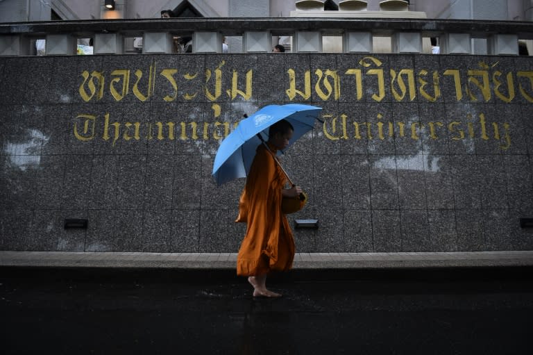 A novice monk walks through Thammasat University after a ceremony to commemorate the 40th anniversary of the October 6, 1976 student massacre