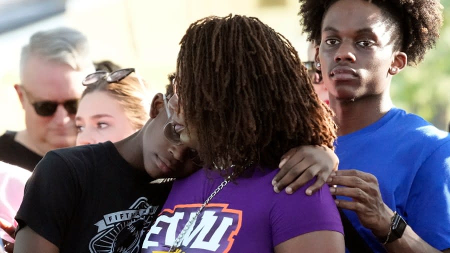 Residents gather Sunday at a prayer vigil for the victims of a mass shooting a day earlier in Jacksonville, Florida. The gunman, before killing three Blacks in a Dollar General store, pulled into a parking lot at Edward Waters University and began putting on tactical gear. (Photo: John Raoux/AP)