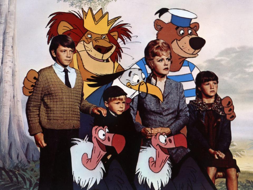 Angela Lansbury with the characters from Bedknobs and Broomsticks