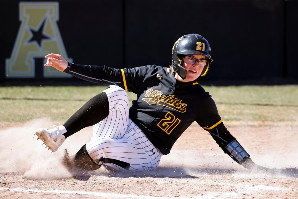 FILE - Wichita State's Krystin Nelson slides at home plate to score on a Sydney McKinney single in the fourth inning of an NCAA college softball game against Northern Colorado, Sunday, March 19, 2023, in Wichita, Kan. McKinney was the No. 1 overall pick in the Athletes Unlimited softball draft on Monday, May 8, 2023. (AP Photo/Colin E. Braley, File)