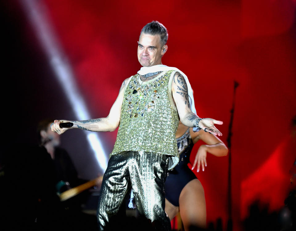 Robbie Williams performing on stage