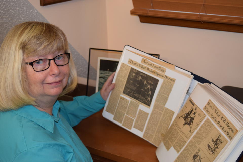 This 2019 photo provided by Cathy Goff shows her with newspaper clippings about the Apollo 11 moon landing mission at her home in King, N.C. In July 1969, the then 14-year-old Cathy, an avid Star Trek and science fiction fan, was spending the week cutting newspaper clippings of the Apollo 11 mission for a school science project: “I remember my mother letting my sister and me stay up late to watch the moon walk. I love anything space related. ... I got to meet Buzz Aldrin at the Star Trek 30th anniversary convention in Huntsville, Alabama. It was one of the greatest thrills of my life!” (Courtesy Cathy Goff via AP)