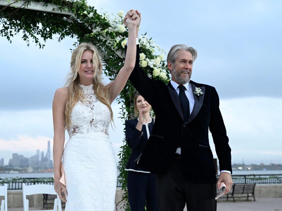 willa and connor on succession, holding their hands up for a wedding on a boat